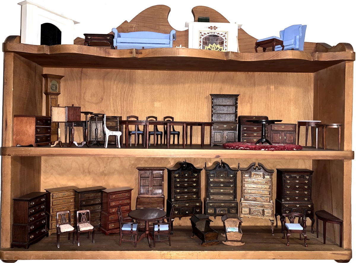 Wall shelf full of completed miniture furniture kits.
